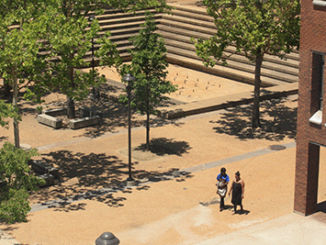 Students walk through the Forest Park courtyard, past the rectangular, concrete fountain, which hasn’t been turned on in years. Some people would like to see it spray water again. (Photo by Garrieth Crockett)