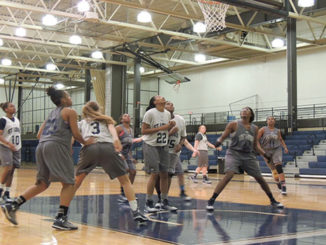 Sophomore forward Brandy Ward, center, anticipates a rebound during a half-court drill. (Photo by Evan Sandel)