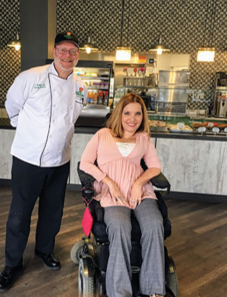  Joe Wilson, culinary director of The Bloom Cafe and a Forest Park graduate, poses with CEO Aimee Wehmeier. She was born with muscular dystrophy. 