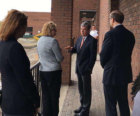 U.S. Sen. Roy Blunt, center, talks to Forest Park Interim Provost Julie Fickas, left, as St. Louis Community College Chancellor Jeff Pittman listens on May 3. They are overlooking the construction site for the new Center for Nursing and Health Sciences on campus.