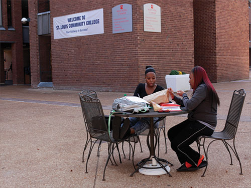 Early childhood education major Jessica Powells Bey, 18, left, and graphic design major Diamond Barber, 18, study on the newly renovated patio. (Photo by Quyen Huynh)