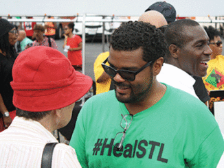 St. Louis City Alderman Antonio French speaks with a protester during a march in Ferguson. (Photo by Evan Sandel)