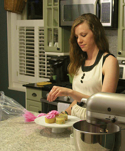 Lia Weber decorates almond raspberry cupcakes at her home. (Photos by Lucian Matoushek)