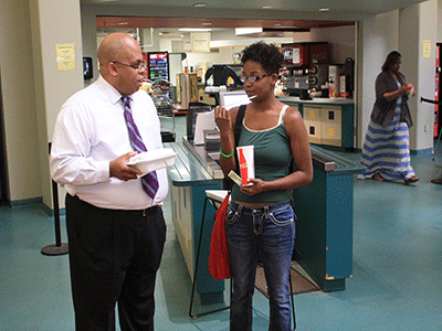 President Roderick Nunn talks with student Alexis Walker in the cafeteria about how she likes the college and her major. (Photo by Garrieth Crockett)