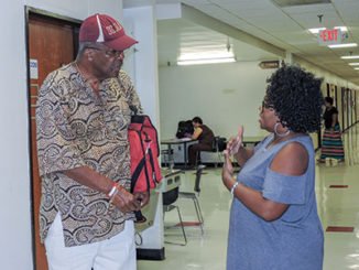Forest Park sociology professor Rodney Wead, 83, talks with with human services major Angela Coleman, 53, outside his office. (Photo by Timothy Bold)
