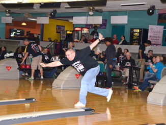 Scott Beck, from the Meramec math department, takes a turn during Bowling for Scholars on April 11. (Photo by Scott Allen)