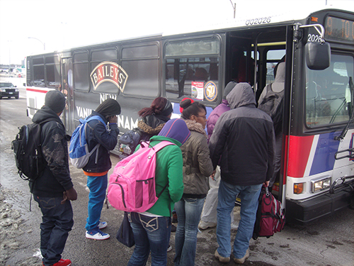 Students crowd onto a bus at the Forest Park stop, unlikely to find a seat. (Photo by DeJuan Baskin)