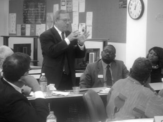 David Coughran addresses the panel as Dean of Allied Health and Natural Sciences Vincent Featherson and Vice President of Academic Affairs Tracy Hall. (Photo by DeJuan Baskin)