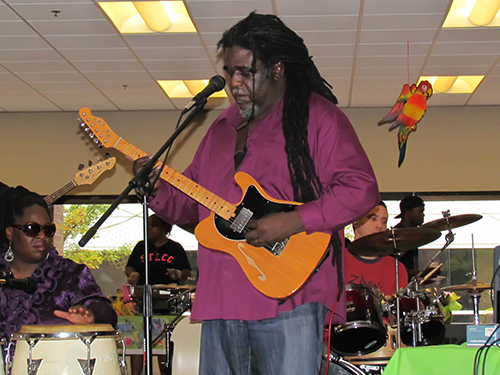Former Forest Park student Ronald Pittman plays reggae music with his band, King Omowale and The Majestic Lions, at a Caribbean event in the cafeteria last year. (Photo by Maryam Thabet )
