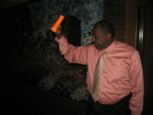Manager of Admissions Glenn Marshall shines a flashlight down a dark staircase. (Photo by Garrieth Crockett) 