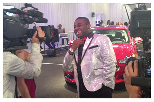 Byron Keaton hams it up for the cameras in front of the red Ford Fusion he won in the Rolling with Ford contest. (Provided photo)