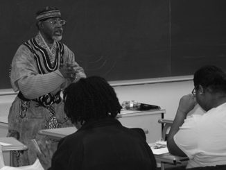 Professor Ronald Henry gives a lesson on Malcolm X in his African American History II class. (Photo by Garrieth Crockett)