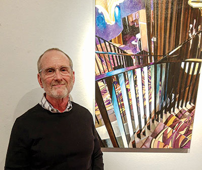 Mark Schatz poses with an acrylic painting he calls “A Thai Restaurant in Vienna.”