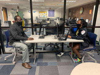 Tutor Dossah A. Edorh works with general transfer student Dina Beaubiant in the Academic Success and Tutoring Center at Forest Park.