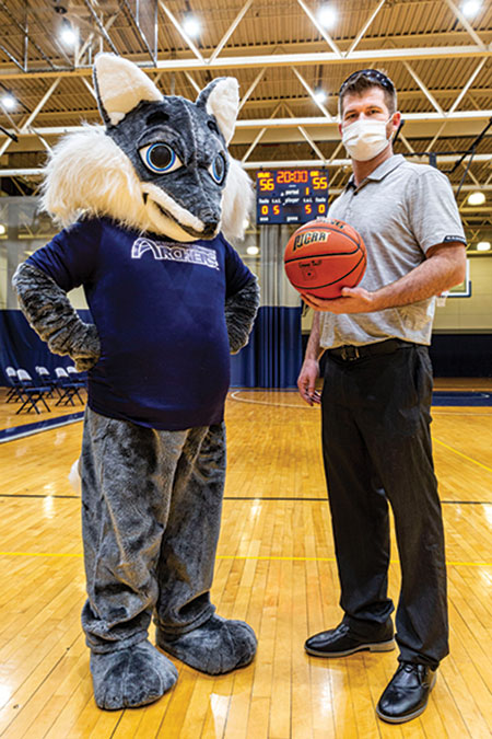Above, STLCC Athletics Director Mike Overman poses with the college’s new mascot, Archie, in the Forest Park gym. Below, items for sale at the campus bookstore feature the new mascot. (Photos by Fred Ortlip)