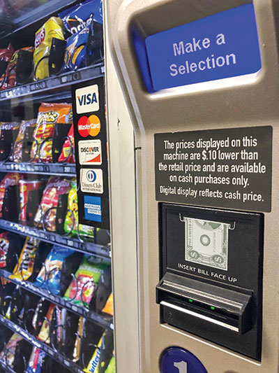 A vending machine on the fourth floor of C Tower offers a 10-cent discount off the retail price of snacks when purchases are made with cash. (Scene staff photo)