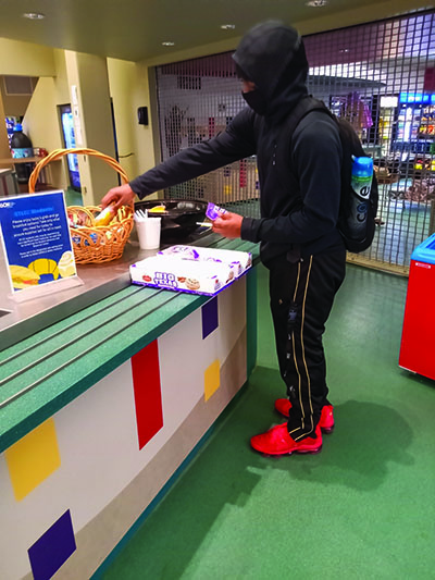 General studies student D.J. Quarles, 18, comes in from the cold for a free breakfast in the Forest Park bookstore. (Photo by Theodore Geigle)