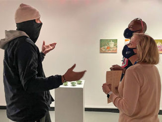 General transfer student Elijah Bishop, 21, chats with Kimberly Hallemann, manager of Academic Success and Tutoring, and English major Aaron Shelton at the Communi-Tea Culture exhibit at the Contemporary Gallery of Art on campus. (Photo by Nicole LeLapp)