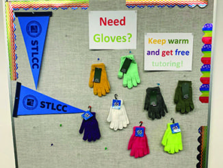 Academic Success and Tutoring uses a bulletin board to promote its programs and give away gloves. (Photo by Leilani England)
