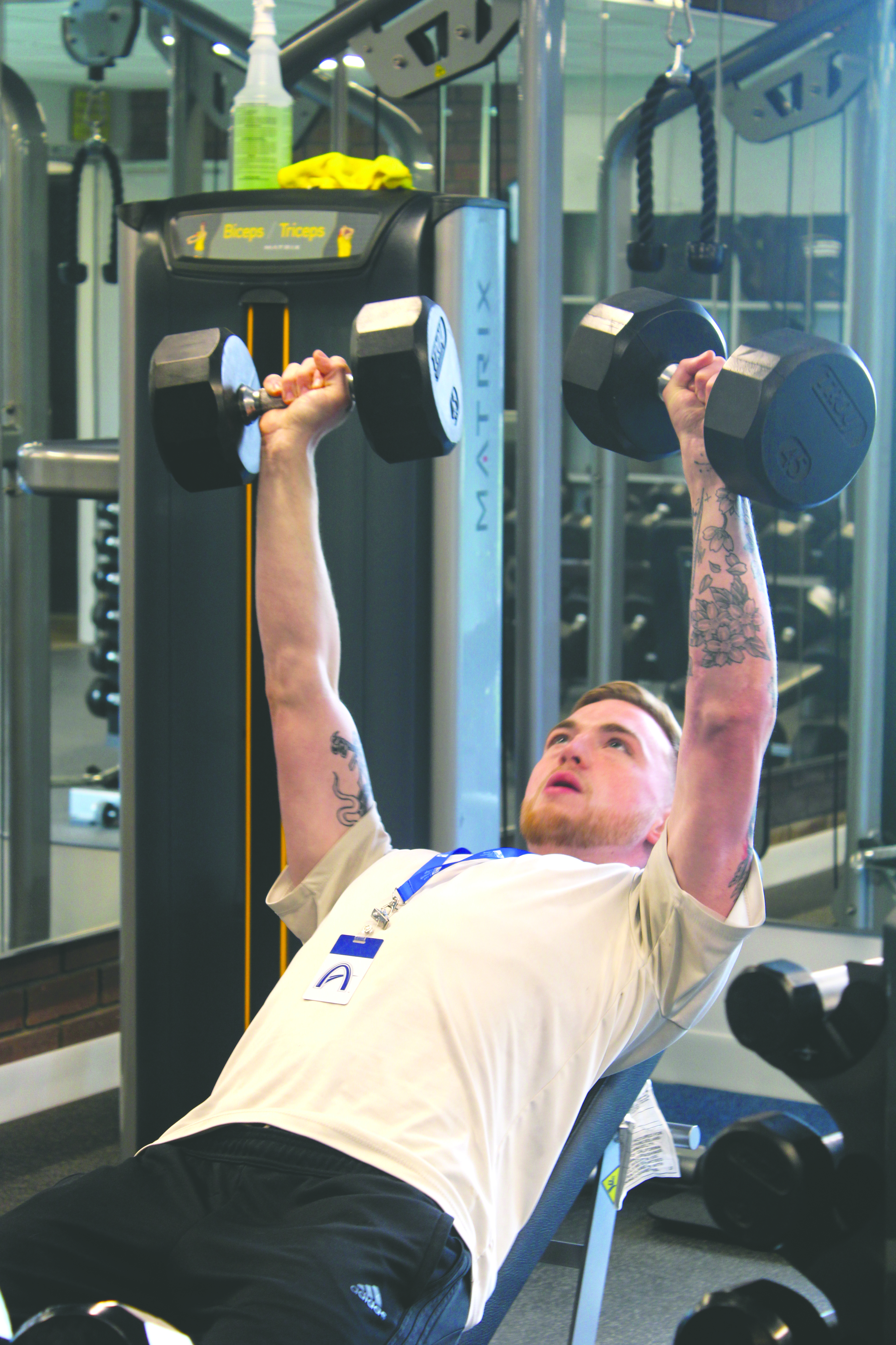 Student worker Collin Jones lifts dumbbells at the new Forest Park fitness center. (Photo by Finn Zimmerman)